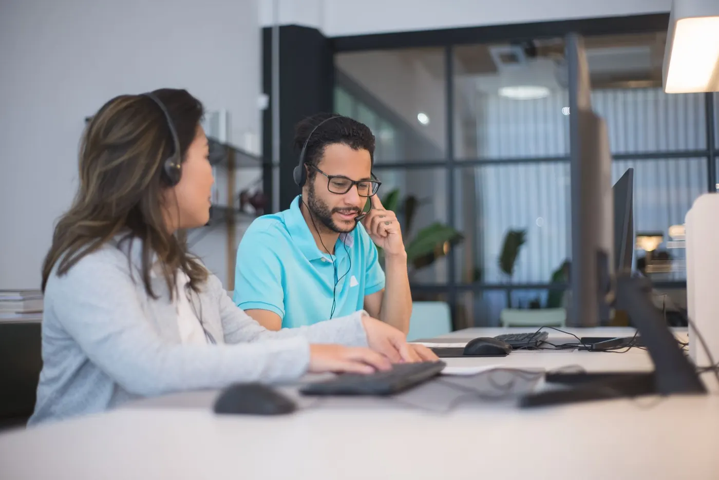 Technicians working together on a client support call